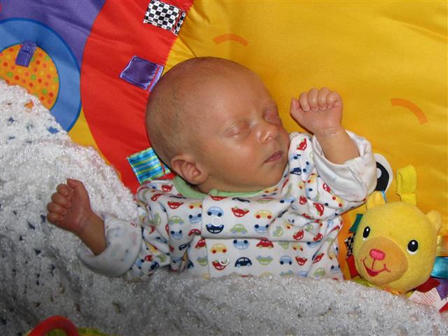 Sleeping well on his activity matt.